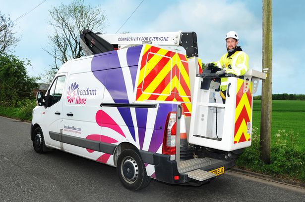 A Freedom Fibre worker on one of the company's vehicles